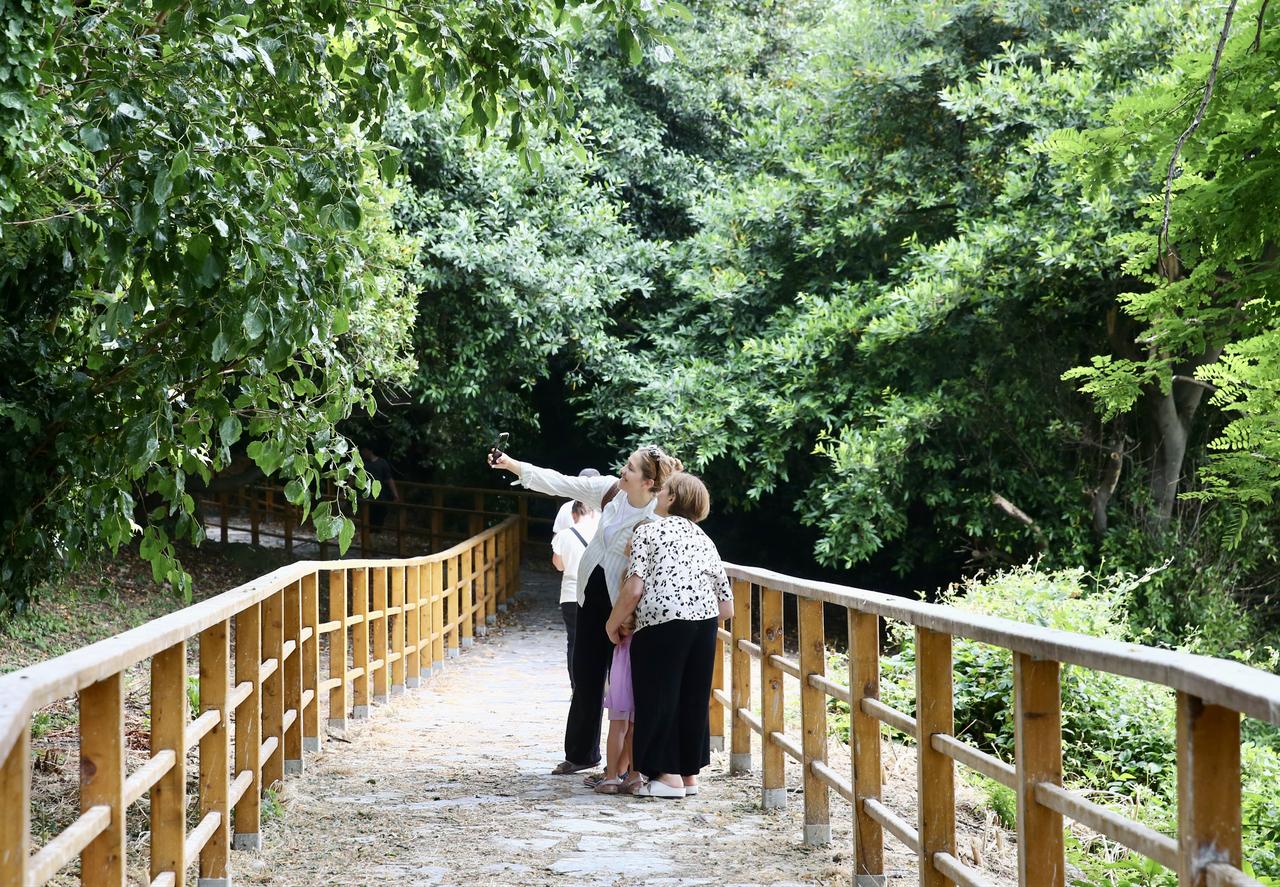 Visitors take photos on a walking path surrounded by greenery on Giresun Island in Giresun, Türkiye, July 10, 2026. (AA Photo)