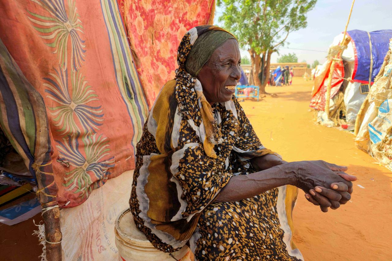 A Sudanese woman sits in al-Rahmaniyah camp for displaced people, near the city of El-Obeid, Sudan, July 7, 2026. (AFP Photo)