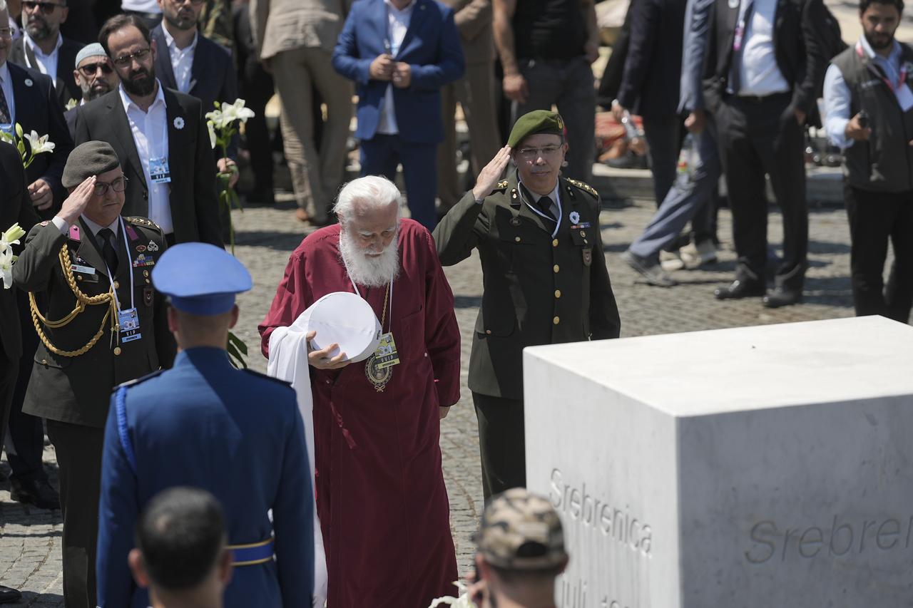 Clergy members and military representatives pay tribute at the memorial monument during a ceremony marking the 31st anniversary of the 1995 Srebrenica genocide at the Potocari Memorial Cemetery during a ceremony marking the 31st anniversary of the 1995 Srebrenica genocide in Potocari, Bosnia and Herzegovina, July 11, 2026. (AA Photo)
