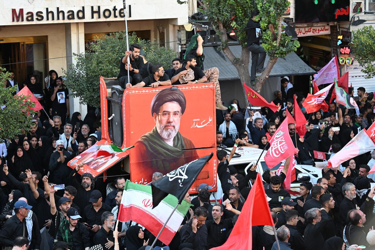 Crowds of mourners gather on a street around a portrait of Iran's supreme leader, Mojtaba Khamenei, ahead of the funeral procession of Iran's slain supreme leader, Ali Khamenei, in Mashhad, July 9, 2026. (AFP Photo)