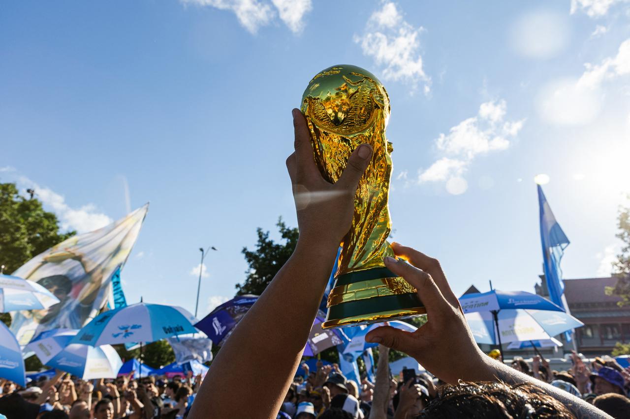 A replica of the FIFA World Cup is lifted by an Argentina's fan on July 10, 2026. (AFP Photo)