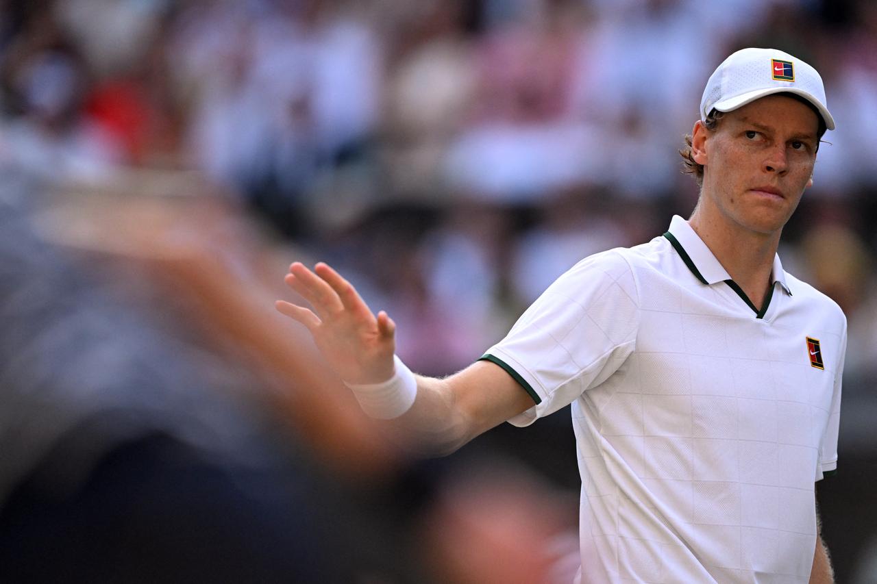 Jannik Sinner reacts as he plays against Serbia's Novak Djokovic during their men's singles semi-final tennis match. (AFP Photo)