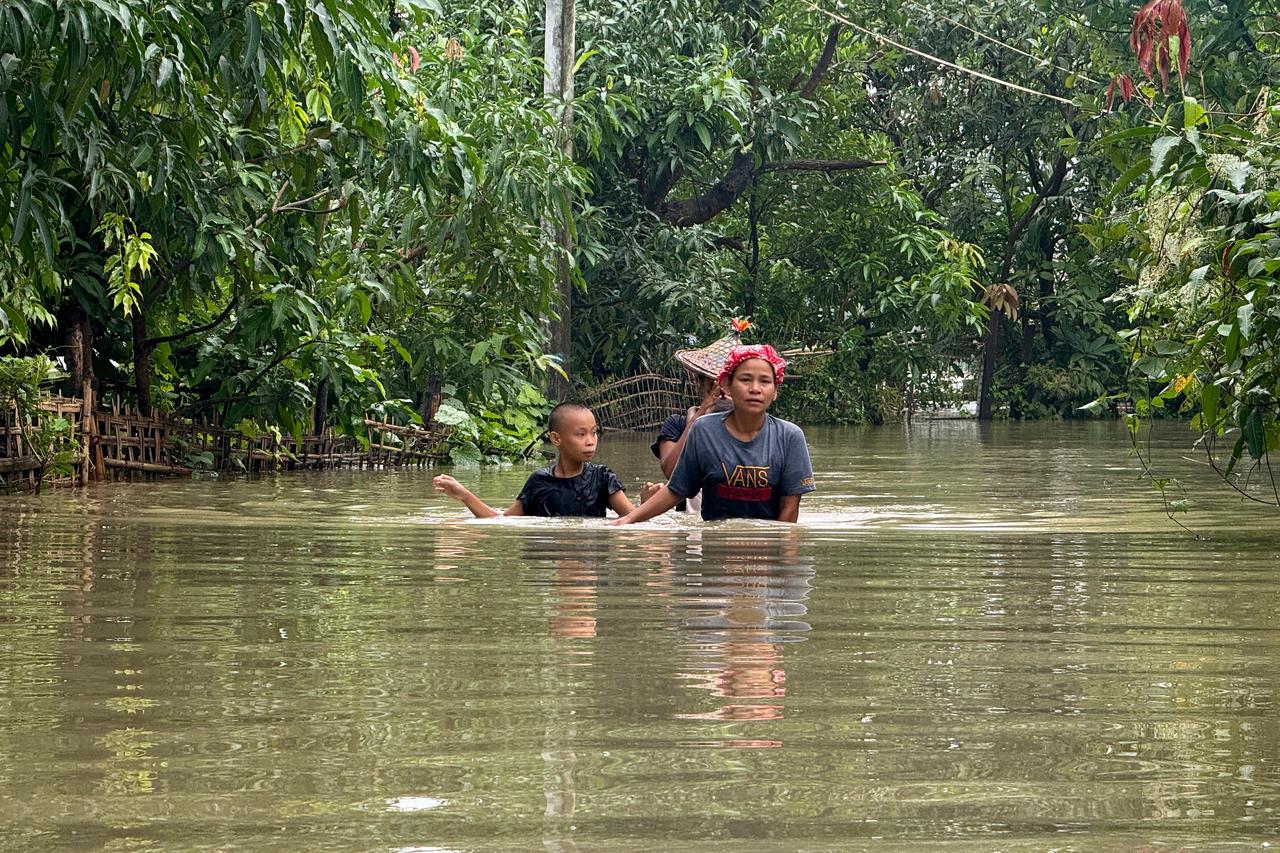 Residents wade through floodwaters in Kyauktaw, Myanmar, July 10, 2026. (AFP Photo)