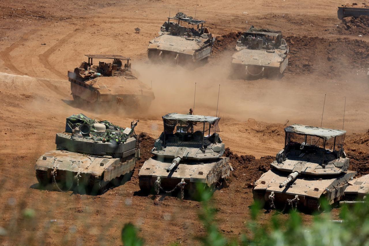 This picture taken from a position in the Upper Galilee in northern Israel shows Israeli army tanks positioned along the Israel-Lebanon border, July 1, 2026. (AFP Photo)