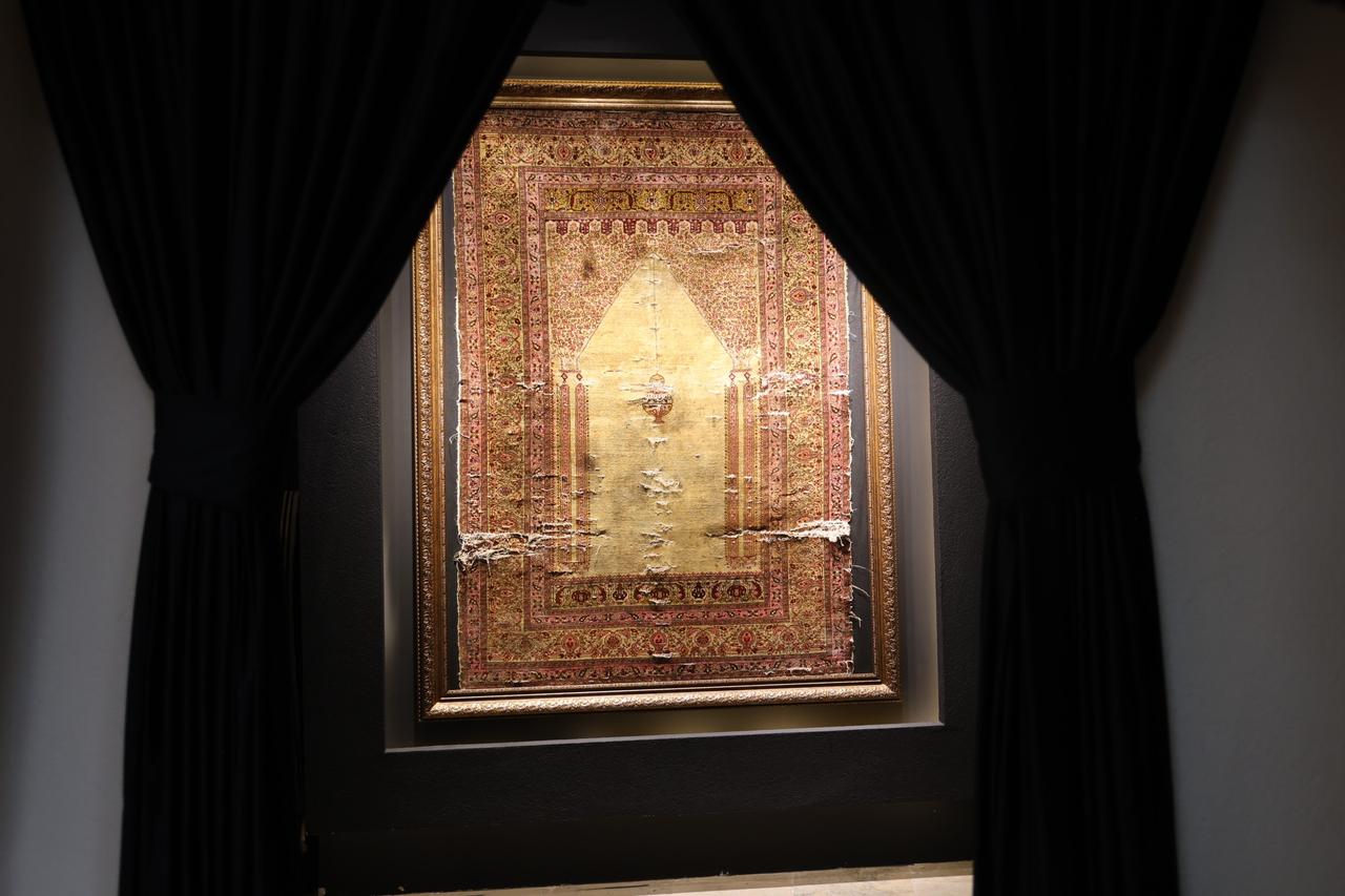 A 300-year-old pure silk carpet, woven in Bursa for Ottoman palaces and preserved without restoration, is displayed in Cappadocia, Türkiye. (IHA Photo)