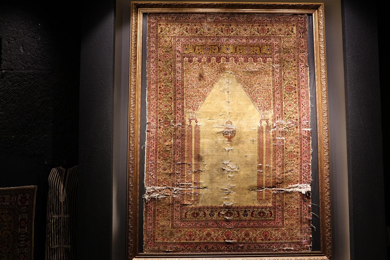 A 300-year-old pure silk carpet, woven in Bursa for Ottoman palaces and preserved without restoration, is displayed in Cappadocia, Türkiye. (IHA Photo)