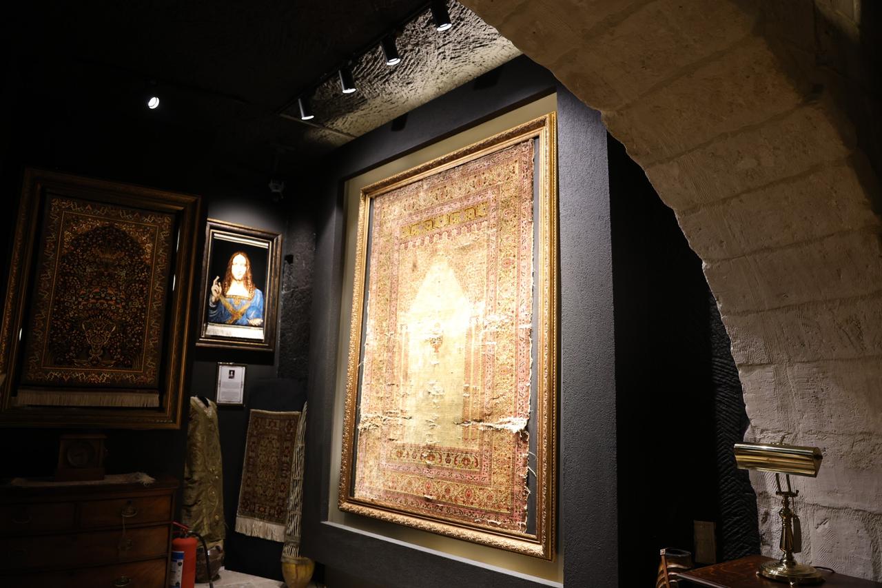A 300-year-old pure silk carpet, woven in Bursa for Ottoman palaces and preserved without restoration, is displayed in Cappadocia, Türkiye. (IHA Photo)