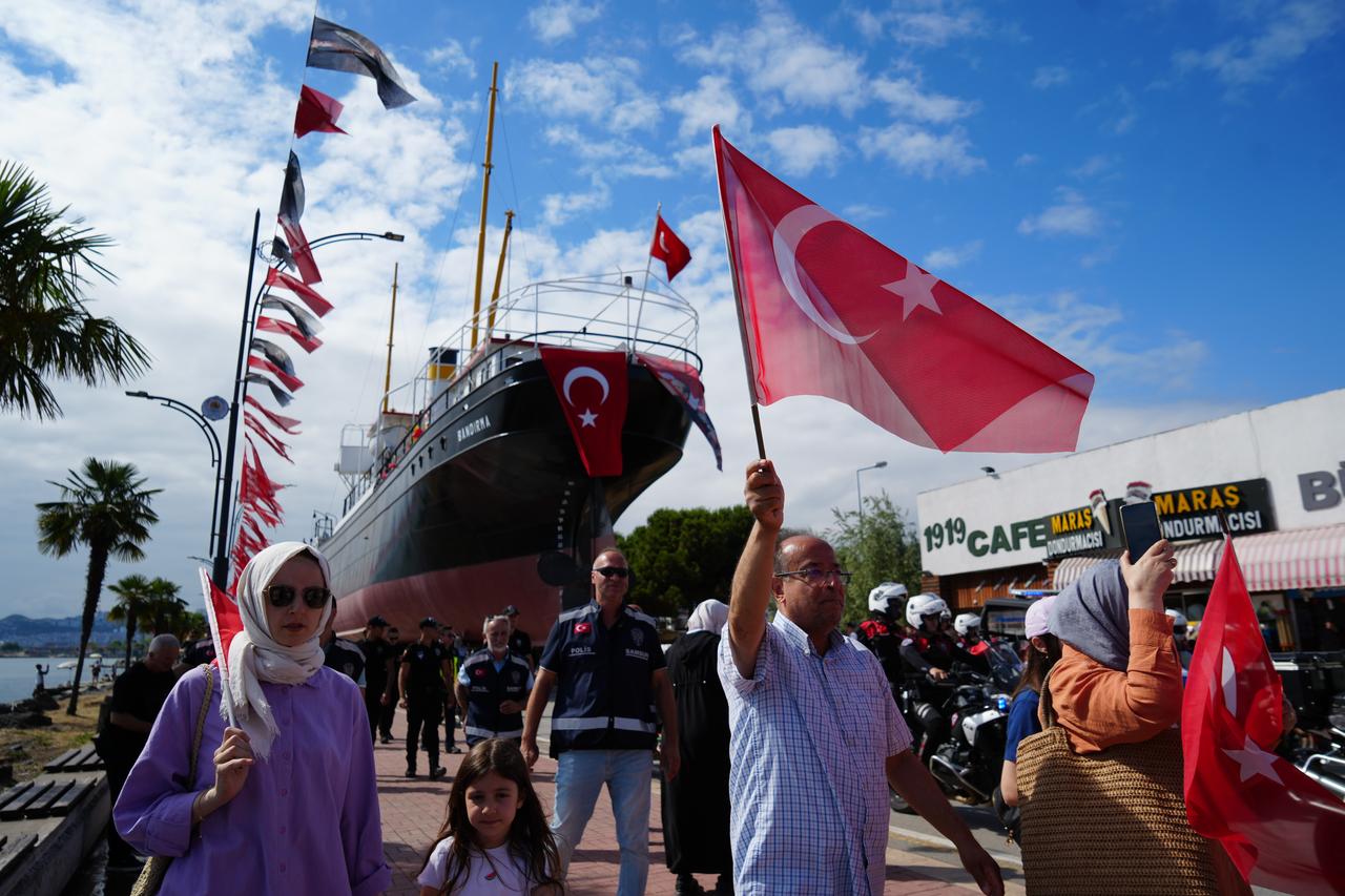 People wave Turkish flags as the Bandirma Ferry Museum is moved by land to its new location near Tutun Pier in Samsun, Türkiye, July 12, 2026. (IHA Photo)