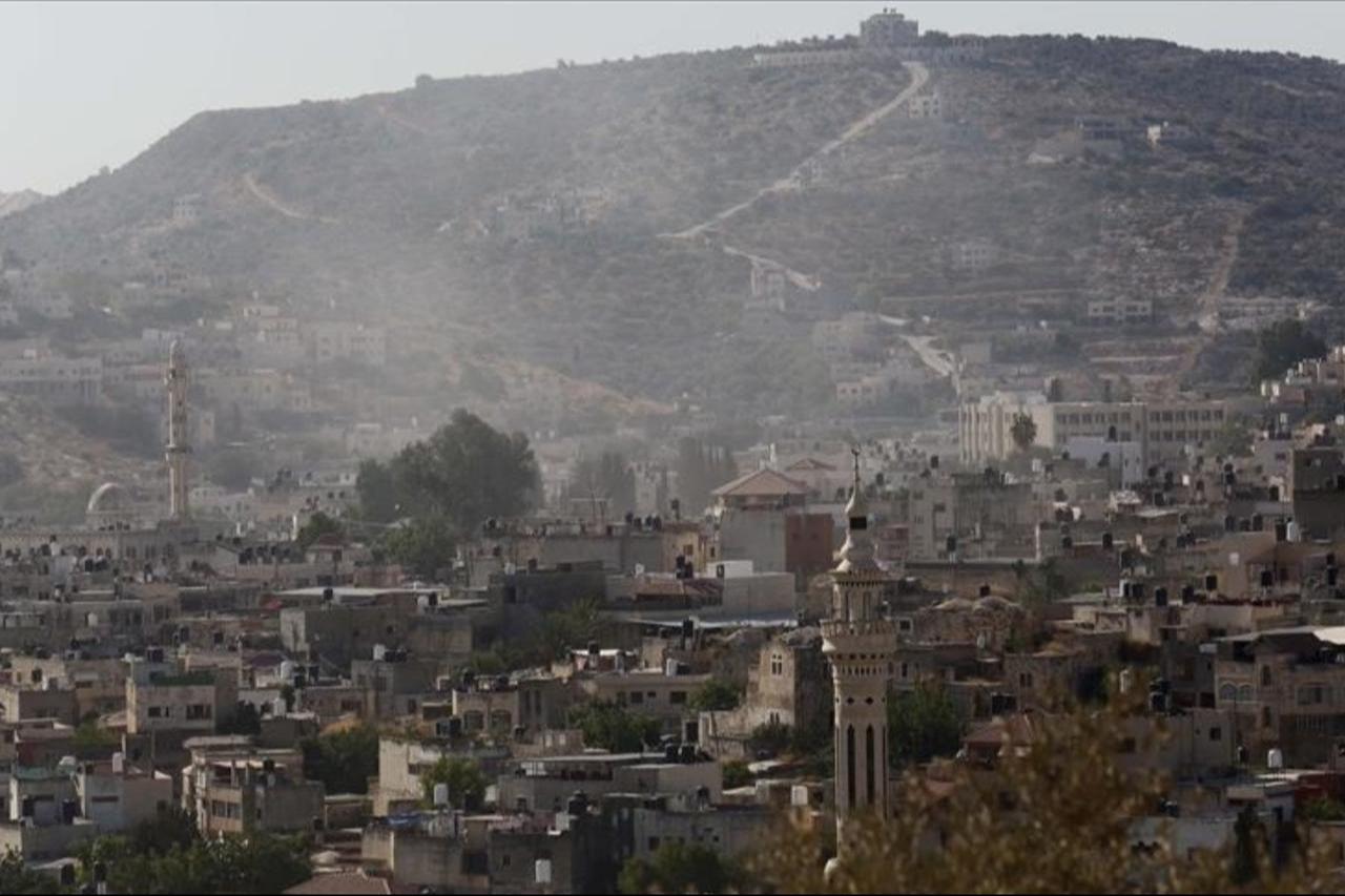 Smoke rises over the area following the Israeli attack on three houses, belonged to Palestinians, in Jenin, West Bank, July 17, 2025. (AA Photo)