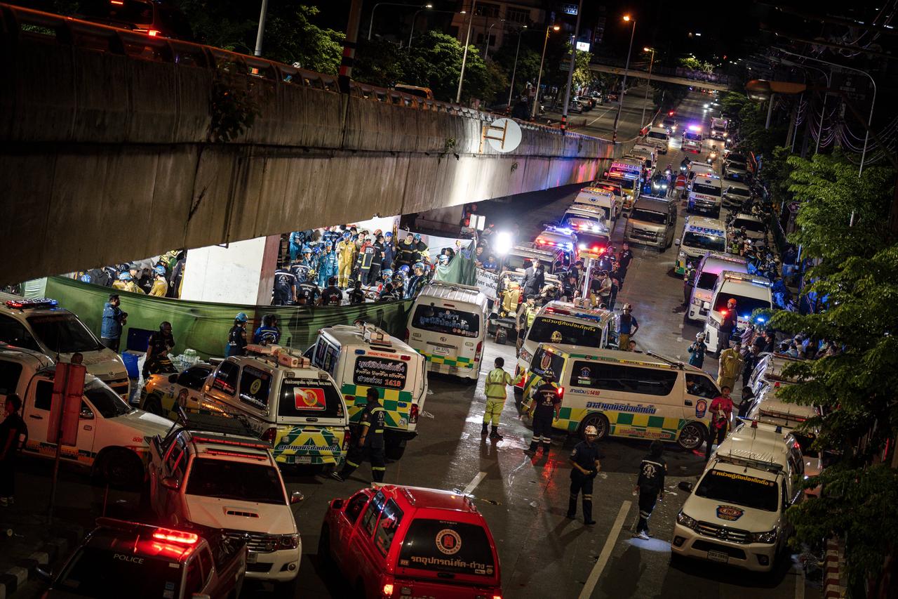 Ambulances parked outside the bar after massive fire broke out in Bangkok, early on July 13, 2026. (AFP Photo)