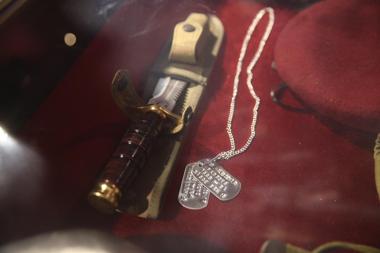 A close-up shows Omer Halisdemir’s military knife and identity tags, preserved among his personal items at the culture center in his hometown of Cukurkuyu. (AA Photo)