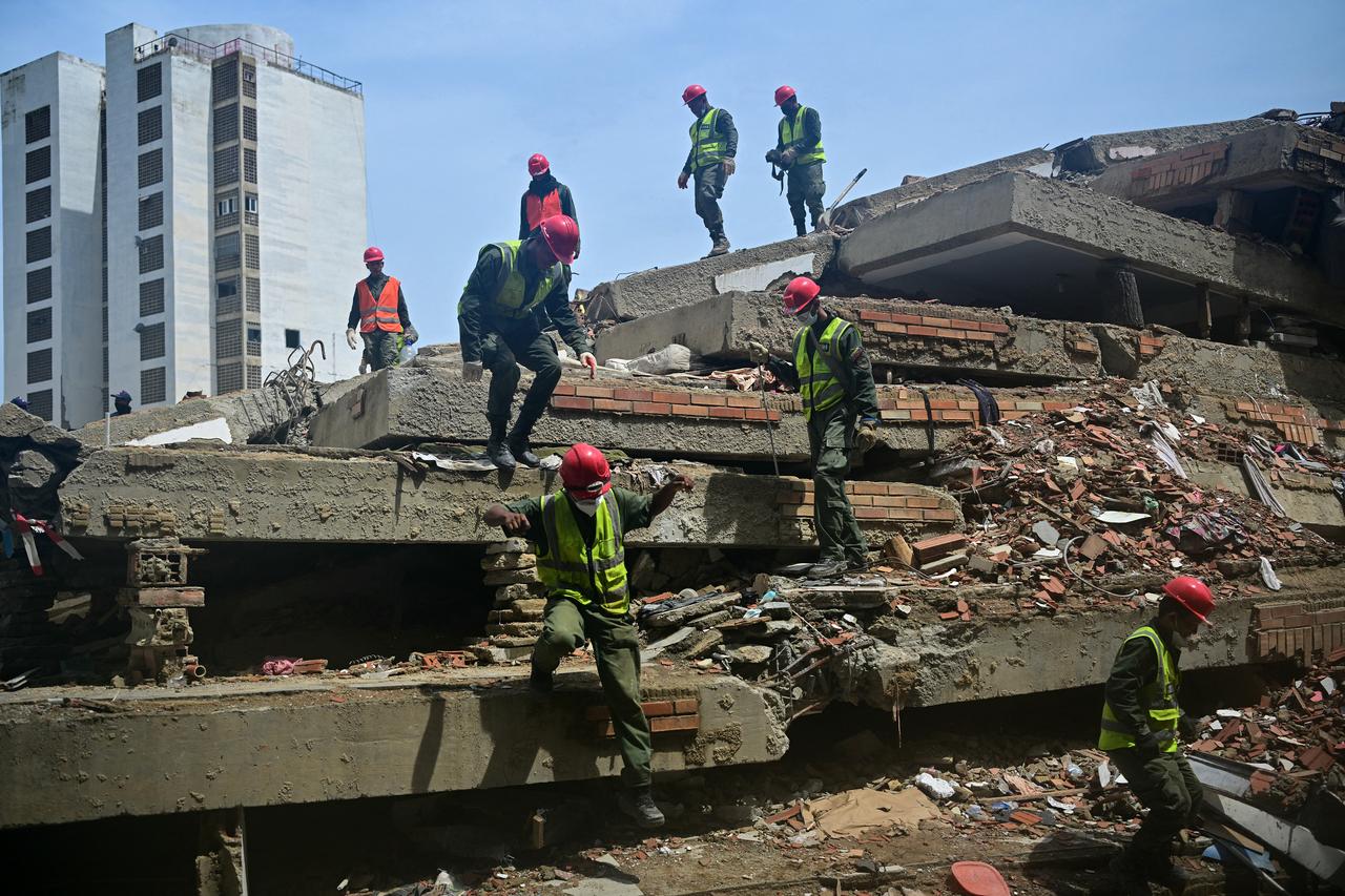Military personnel work atop a collapsed building in Caraballeda, La Guaira state, Venezuela, on July 12, 2026, following twin earthquakes that struck the region. (AFP Photo)