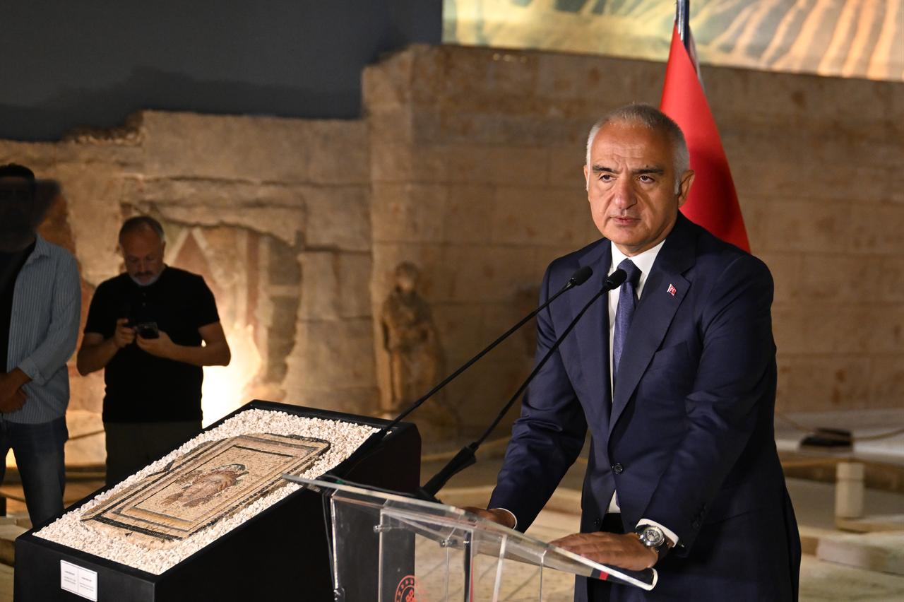 Türkiye’s Culture and Tourism Minister Mehmet Nuri Ersoy addresses attendees beside the 13th panel of the Zeugma mosaic, which was recovered from the United States and returned to Türkiye, at the Zeugma Mosaic Museum in Gaziantep, July 14, 2026. (AA Photo)