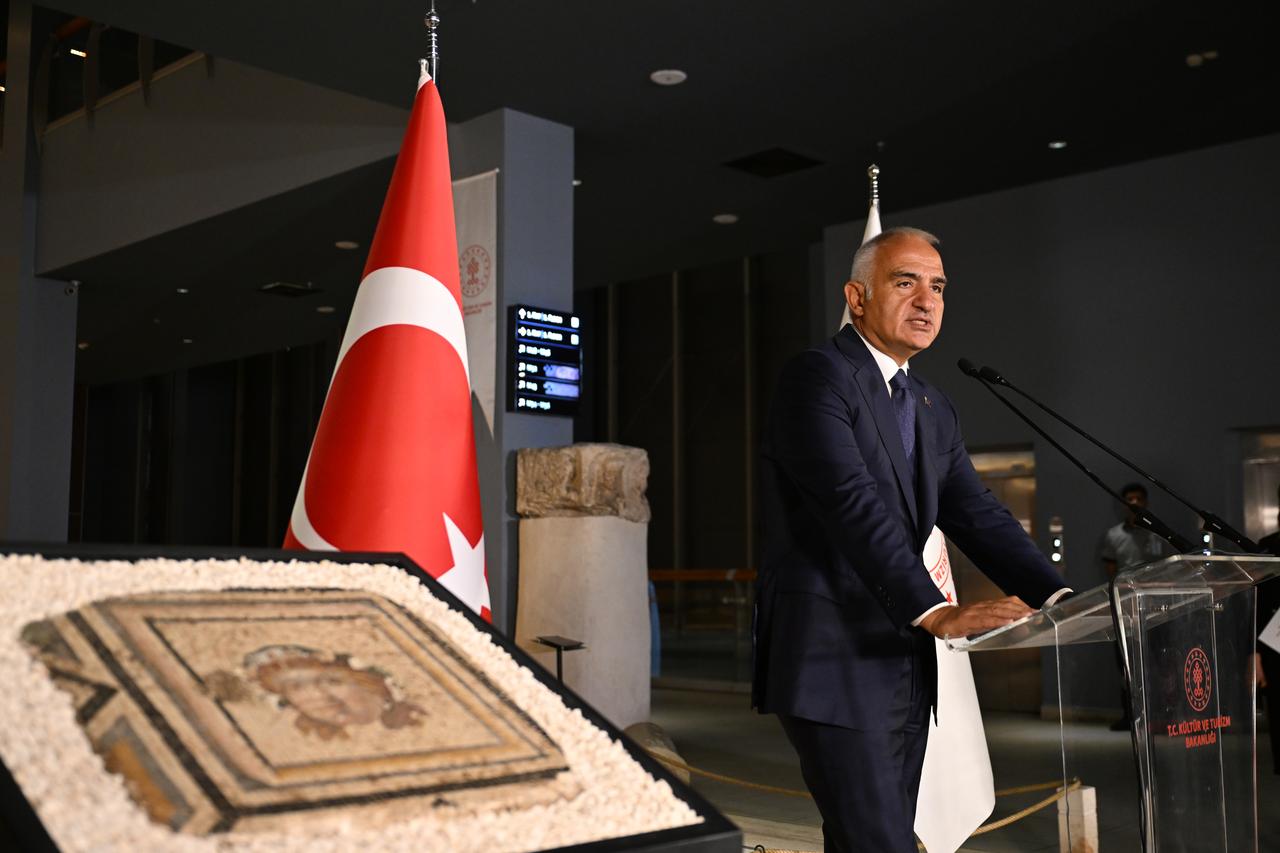 Türkiye’s Culture and Tourism Minister Mehmet Nuri Ersoy addresses attendees beside the 13th panel of the Zeugma mosaic, which was recovered from the United States and returned to Türkiye, at the Zeugma Mosaic Museum in Gaziantep, July 14, 2026. (AA Photo)