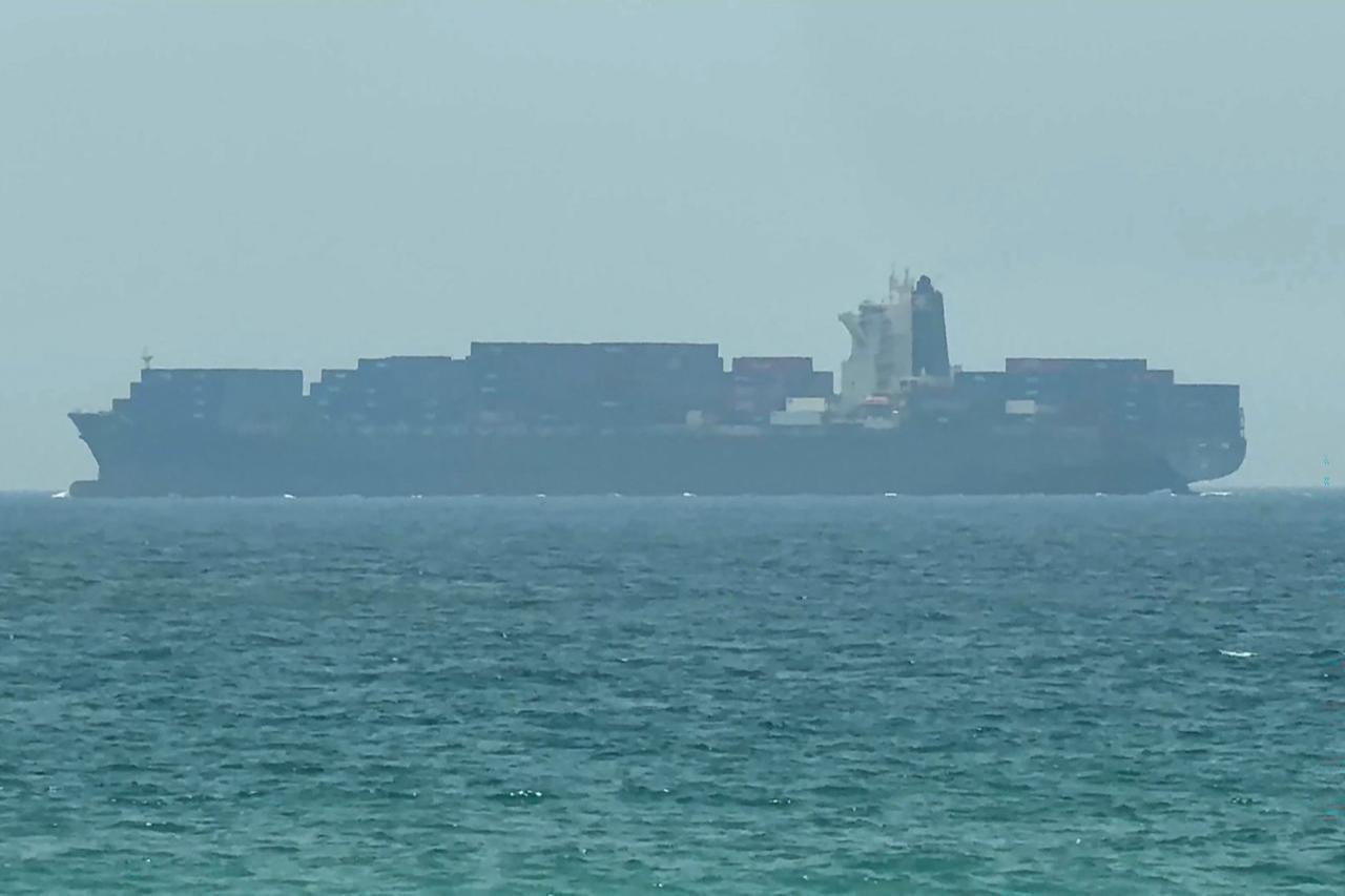 This frame grab taken from AFPTV video footage on July 12, 2026 shows a cargo ship anchoring near the Strait of Hormuz off the eastern coast of the United Arab Emirates at Khor Fakkan. (AFP Photo)