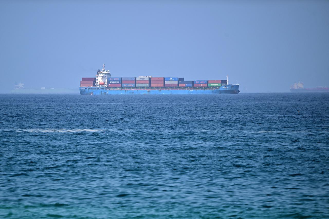 A cargo ship is pictured off coast of the Khor Fakkan Container Terminal, the only natural deep-sea port in the region and one of the major container ports in Sharjah Emirate, along the Gulf of Oman, June 28, 2026. (AFP Photo)