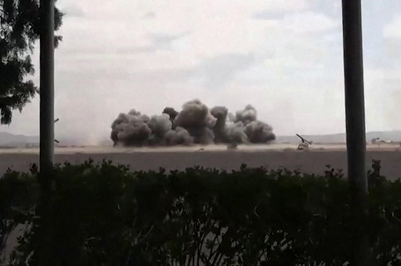 This screen grab taken from video footage released by the Houthi rebels' Al-Masirah TV channel and made available via AFPTV on July 13, 2026, shows airstrikes hitting Sanaa airport. (AFP Photo/Al-Masirah via AFPTV/HO)