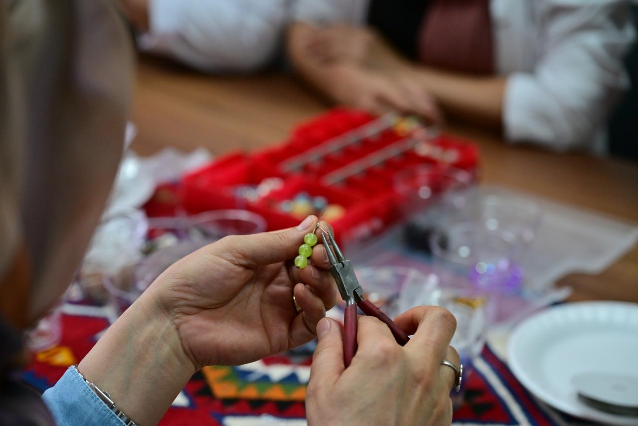 Participants design handmade accessories using natural stones during the Jewelry Design Workshop at the Van Maturation Institute in Van, Türkiye. (AA Photo)