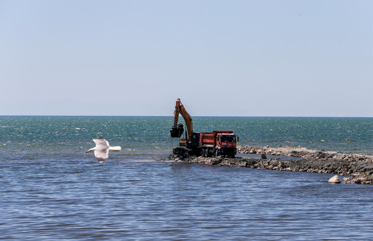 An excavator loads sludge removed from Lake Van into a truck during shoreline cleanup operations in Van, Türkiye, July 15, 2026. (AA Photo)