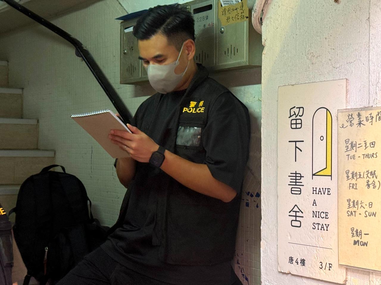 Policeman stands at the entrance to the "Have A Nice Stay" independent bookstore after the officers raid on July 15, 2026. (AFP Photo)