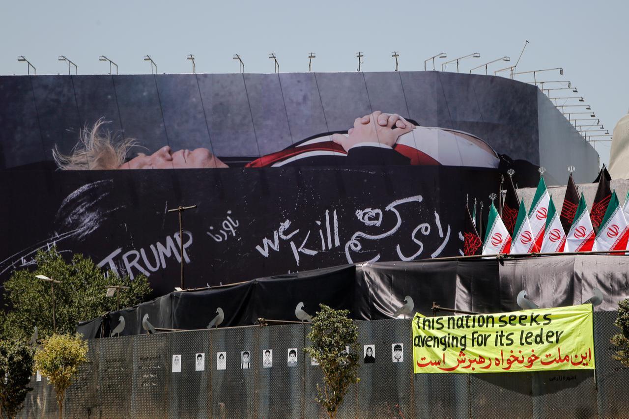 A view of a billboard depicting US President Donald Trump lying in a "black coffin" made of concrete barriers is hung at Enghelab (Revolution) Square with slogans written on the ''coffin walls'', July 15, 2026 in Tehran, Iran. (AA Photo)