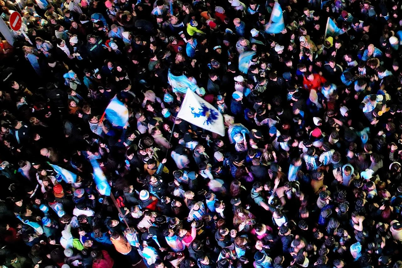 In this aerial view a flag with the map of the Falkland Islands (Islas Malvinas) (C) is seen as fans celebrate Argentina's victory over England in the 2026 FIFA World Cup semi-final football match in Ushuaia, Argentina, July 15, 2026. (AFP Photo)