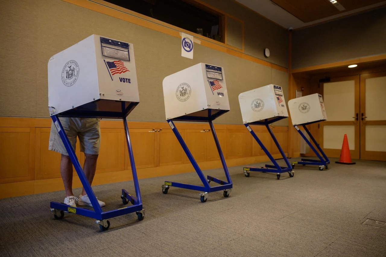 A voter stands in a booth at a voting station at the Metropolitan Museum of Art (MET) during the mayoral election process in New York, June 12, 2021. (AFP Photo)