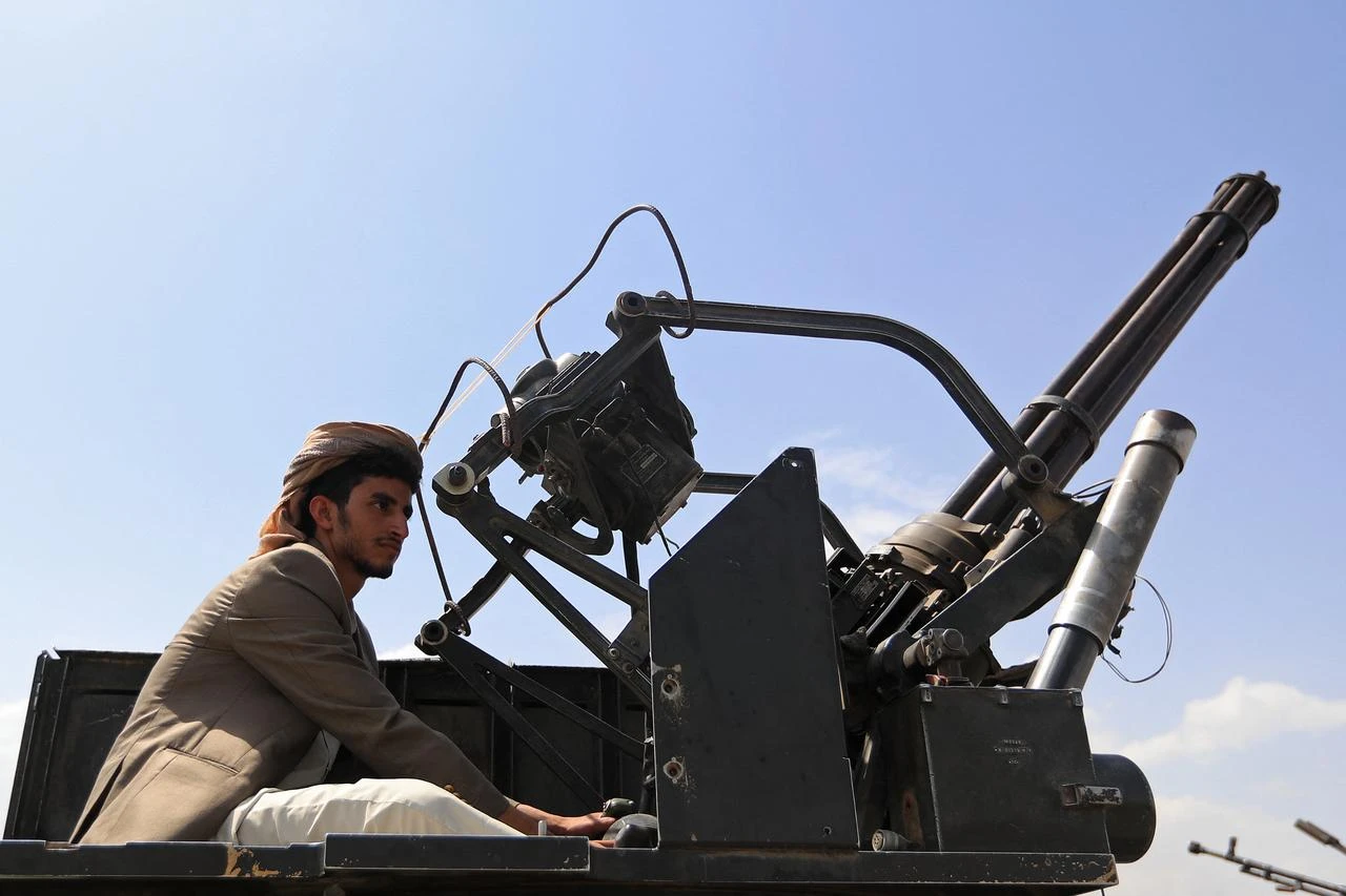 A Yemeni gunman brandishes his weapon during a rally to recruit more in Sanaa on July 6, 2026. (AFP Photo)