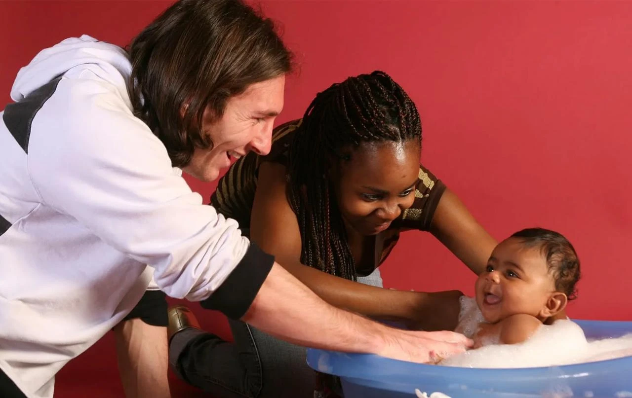 Lionel Messi and Sheila Ebana bathe baby Lamine Yamal during a photo session at Camp Nou in Barcelona, Spain, September 2007. (Photo by Joan Monfort via X/@UNICEF)