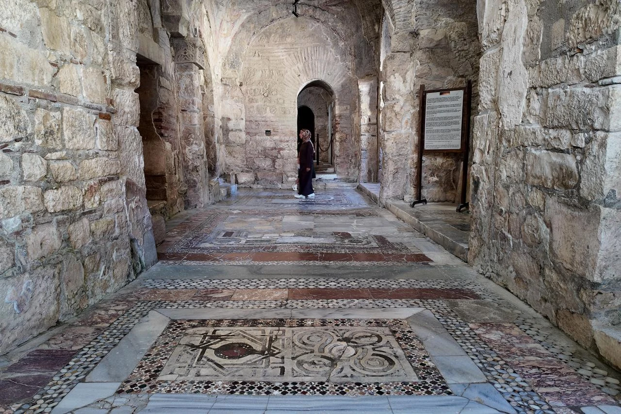 A visitor walks through the mosaic-covered interior of St. Nicholas Church in Demre, Antalya, Türkiye, July 17, 2026. (AA Photo)
