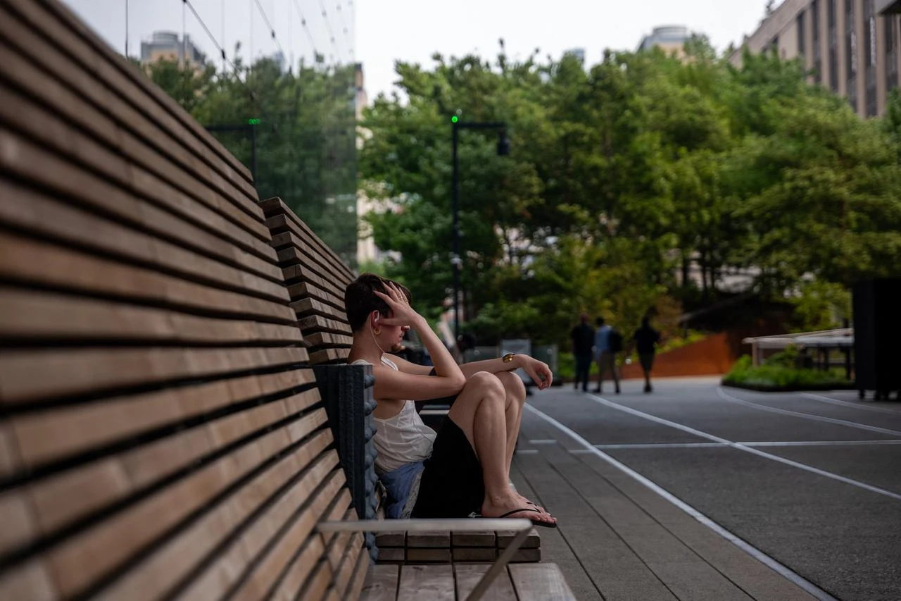 A man sits on a bench during intense heat in Manhattan in New York City, July 15, 2026. (AFP Photo)
