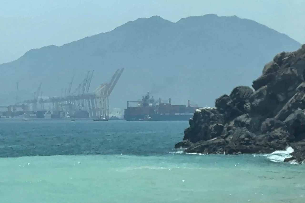 This frame grab taken from AFPTV video footage on July 12, 2026 shows a ship sailing near the Strait of Hormuz off the eastern coast of the United Arab Emirates at Khor Fakkan. (AFP Photo)