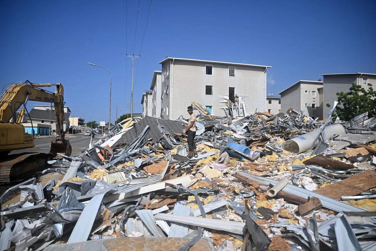 A man searches for reusable materials amid debris at the Urbanismo Comunidad Socialista Residencias Hugo Chavez in Catia La Mar, La Guaira state, Venezuela, July 15, 2026 (AFP Photo)