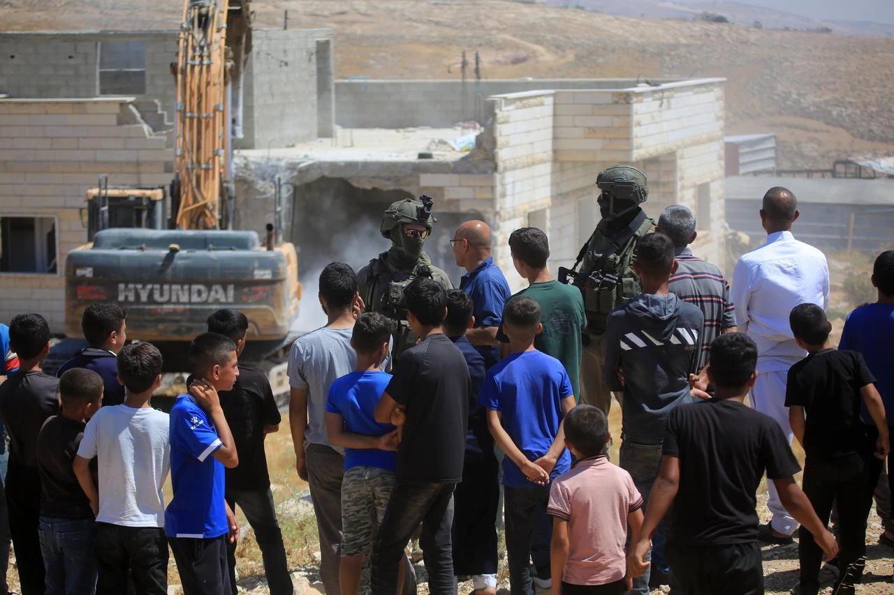 Israeli forces stand by in the area as the Israeli military demolish two Palestinian homes on the grounds that they had been built without permits in Masafer Yatta, south of Hebron, West Bank, Palestine on July 07, 2026. (AA Photo)