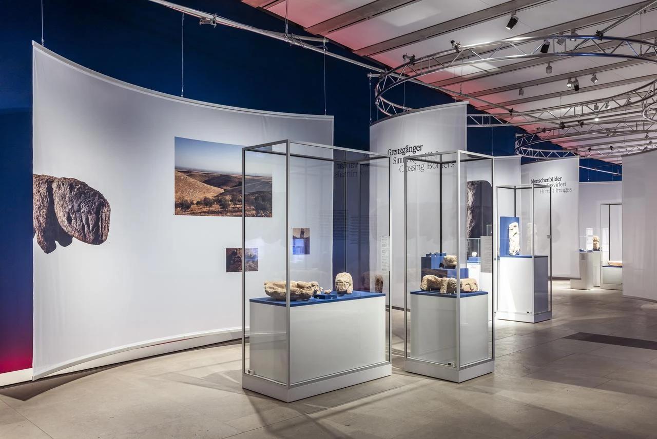 A carved animal sculpture and prehistoric tools are displayed at the “Built Community” exhibition at the James Simon Galerie in Berlin, Germany. (Photo by David von Becker, courtesy of Staatliche Museen zu Berlin, Vorderasiatisches Museum)