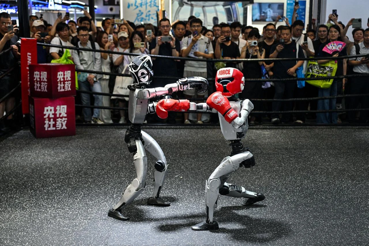 Humanoid robots controlled by a remote control by Unitree Robotics take part in a fight during the World Artificial Intelligence Conference (WAIC) in Shanghai on July 18, 2026. (AFP Photo)