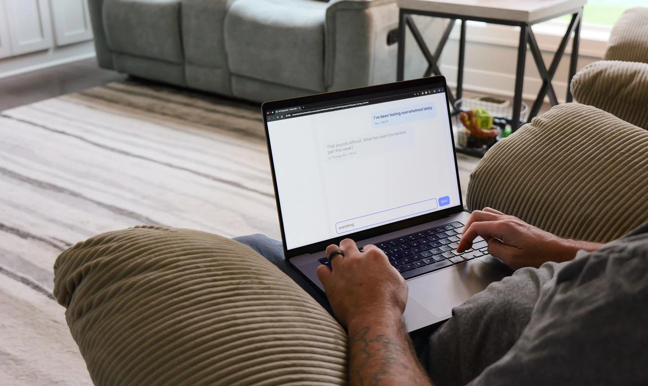 A person uses an AI-powered mental health chatbot on a laptop at home. (Adobe Stock Photo)