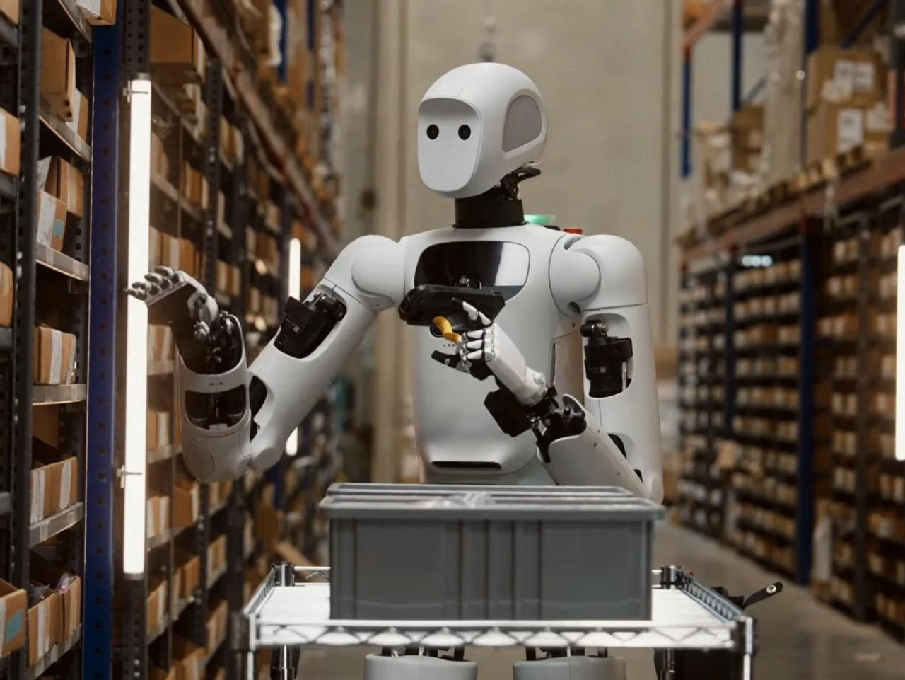 A humanoid robot handles inventory during warehouse training at a robotics facility, July 18, 2026. (AA Photo)