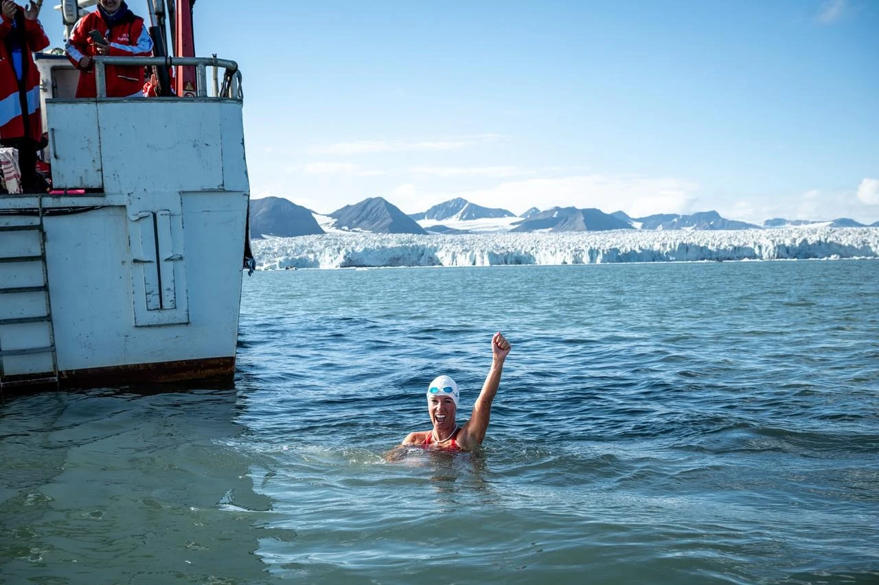 Turkish swimmer Deniz Kayadelen celebrates after swimming in Arctic waters near the North Pole, July 18, 2026. (AA Photo)