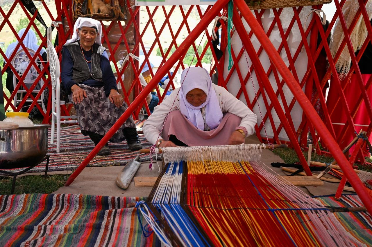 A Kyrgyz woman weaves a traditional textile inside a yurt during the 12th Ulupamir Cultural Festival in Van, Türkiye, July 18, 2026. (AA Photo)