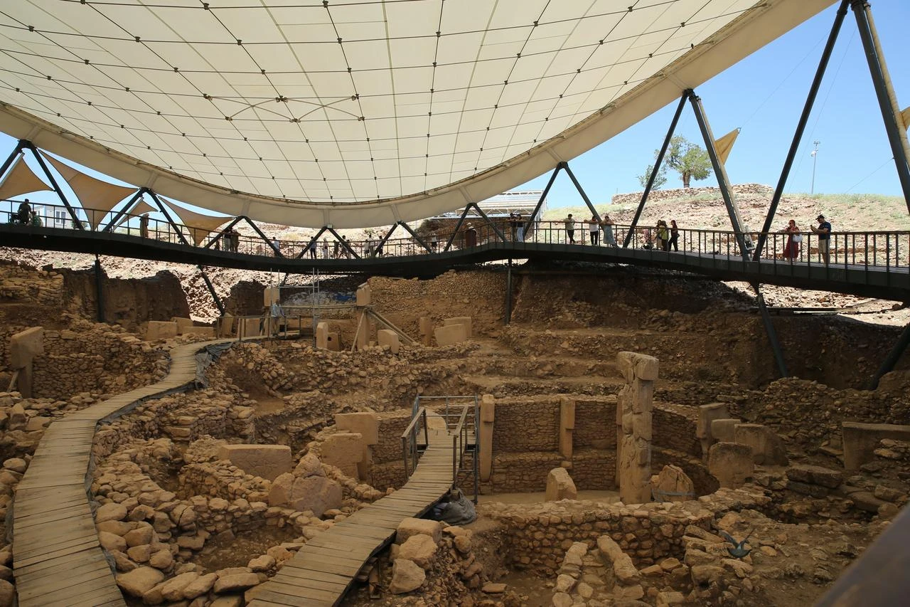 Visitors tour Gobeklitepe under the site’s protective canopy, as the UNESCO World Heritage site continues to draw global attention. (AA Photo)
