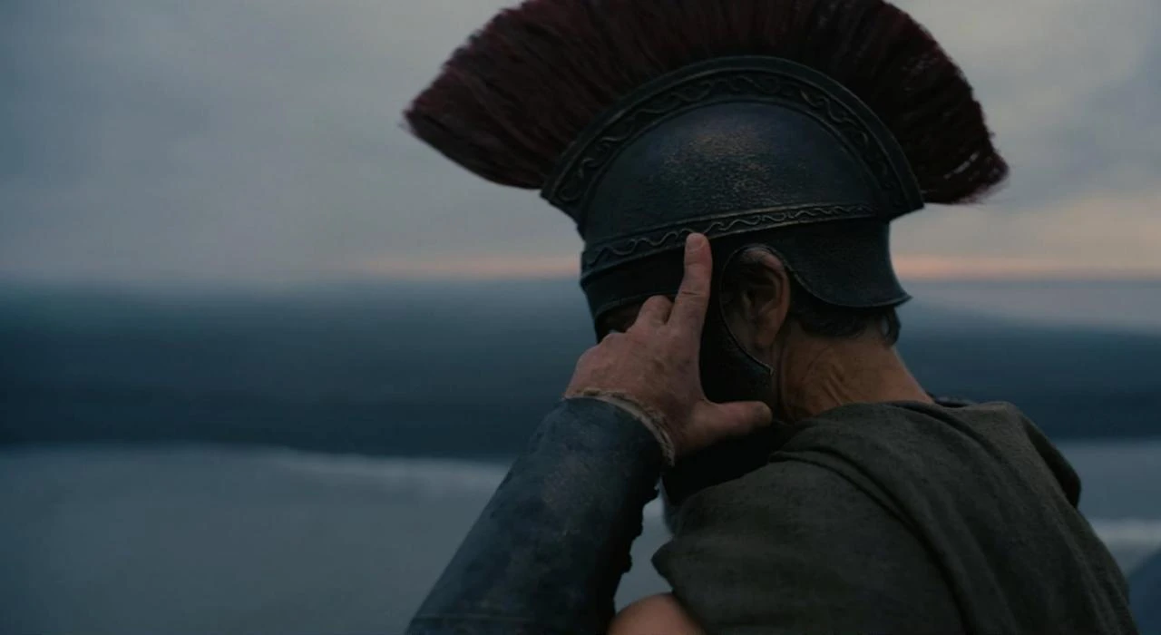 A close-up scene from "The Odyssey" shows an armored warrior looking out over the sea. (Photo via IMDb)