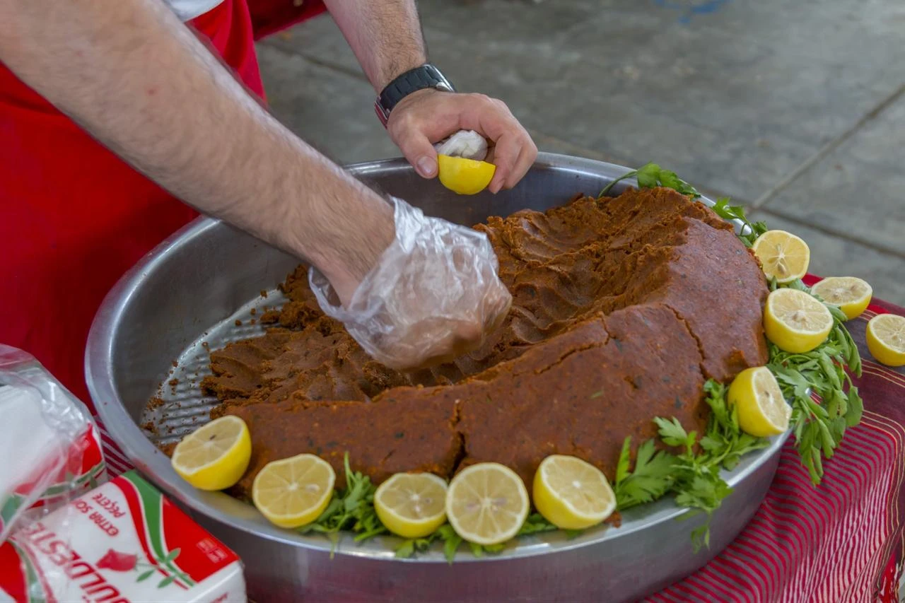 The vigorous, rhythmic kneading process is essential to perfecting cig kofte. (Adobe Stock Photo)