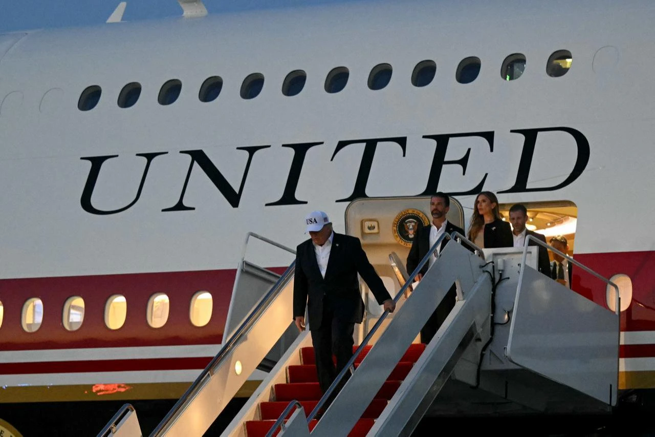 US President Donald Trump (L), his son Donald Trump Jr. and his daughter-in-law Bettina Anderson disembark from Air Force One at Joint Base Andrews, Maryland, July 1, 2026. (AFP Photo)