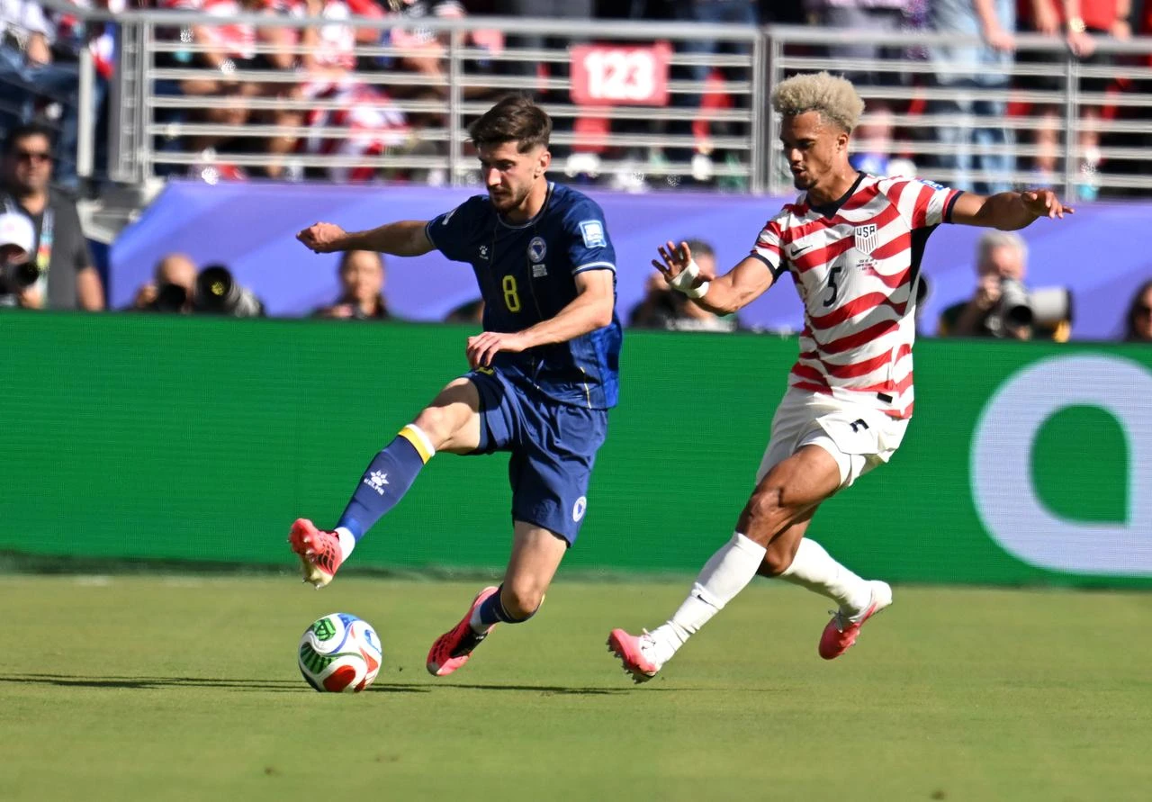 Antonee Robinson (5) of USA in action against Armin Gigovic (8) of team Bosnia Herzegovina during the 2026 FIFA World Cup Round 32 match between USA vs Bosnia and Herzegovina at the San Francisco Bay Area Stadium (Levi's Stadium) in Santa Clara, California, United States, July 1, 2026. (AA Photo)