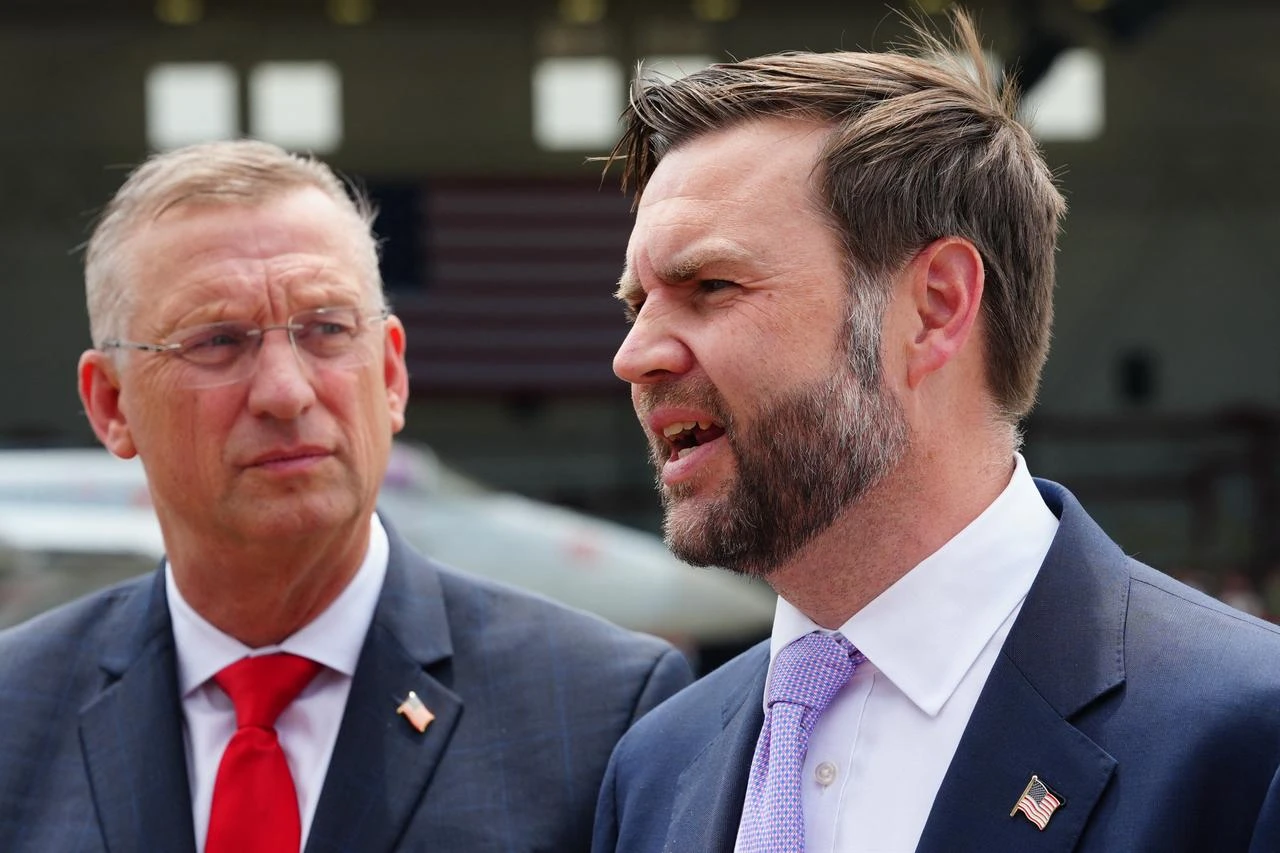 US Secretary for Veterans Affairs Doug Collins (L) listens as US Vice President JD Vance speaks to reporters following an event at Naval Air Station Oceana in Virginia Beach, Virginia, July 1, 2026. (AFP Photo)