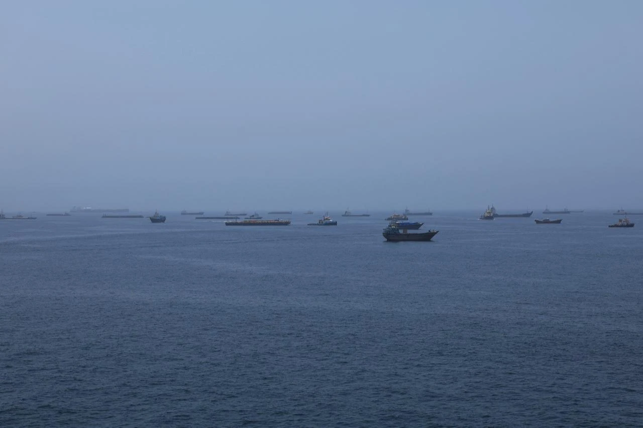 A view of commercial cargo vessels and crude oil tankers are anchored in the Gulf of Oman, off the coast of Muscat, Oman, June 21, 2026, as they prepare to transit through Strait of Hormuz. (AA Photo)