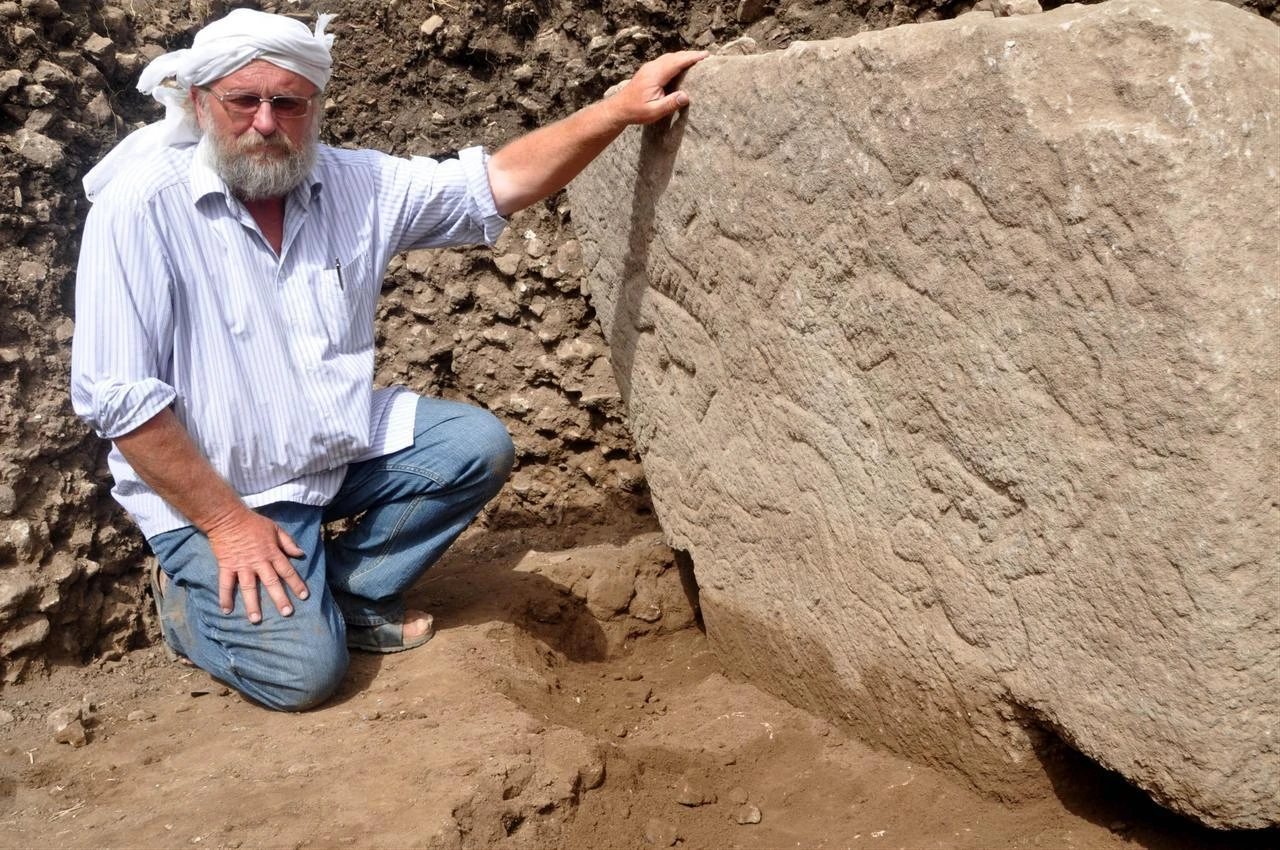 German archaeologist Klaus Schmidt, known for leading excavations at Gobeklitepe in Sanliurfa, poses in front of the excavation site, accessed on July 20, 2026. (AA Photo)