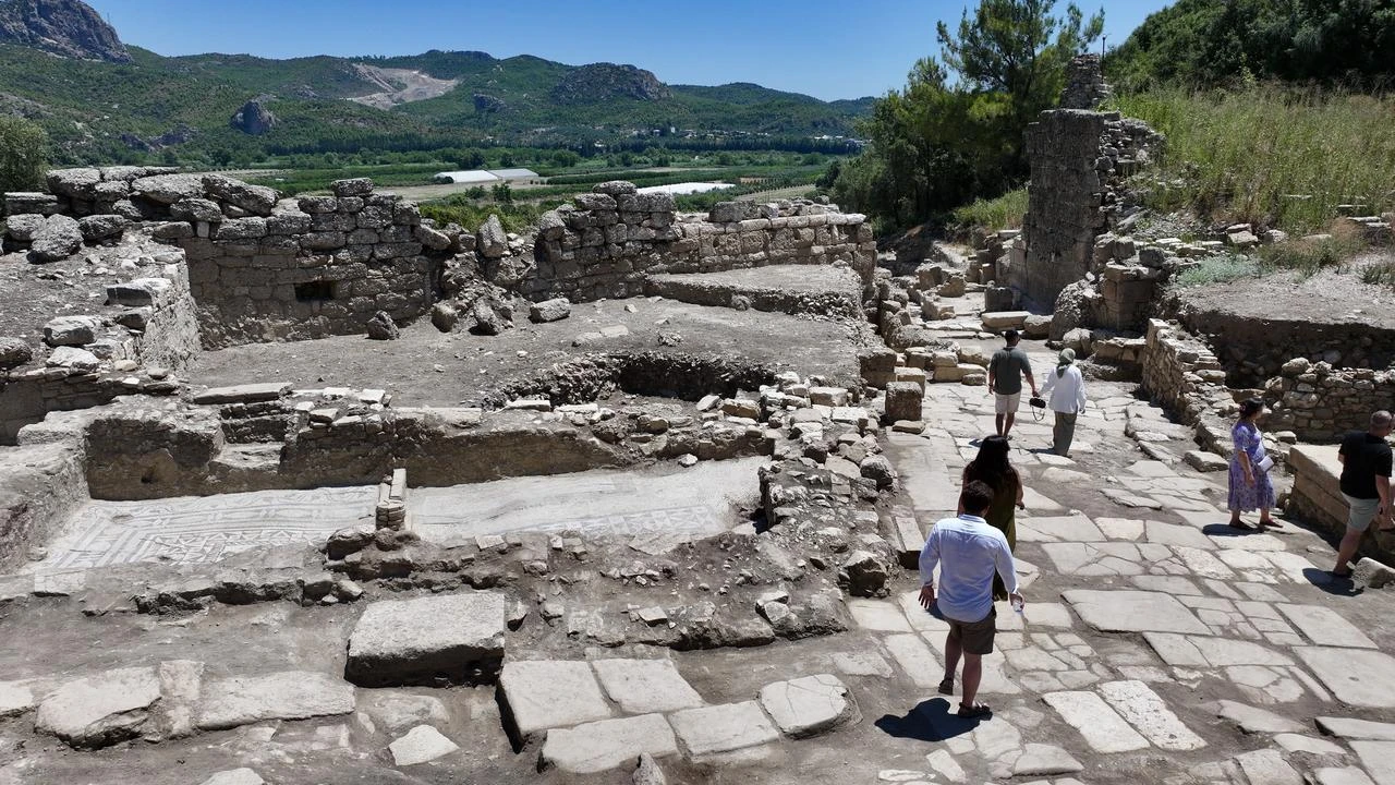 Visitors walk along the restored main street of the ancient city of Aspendos in Antalya, Türkiye, July 21, 2026. (AA Photo)