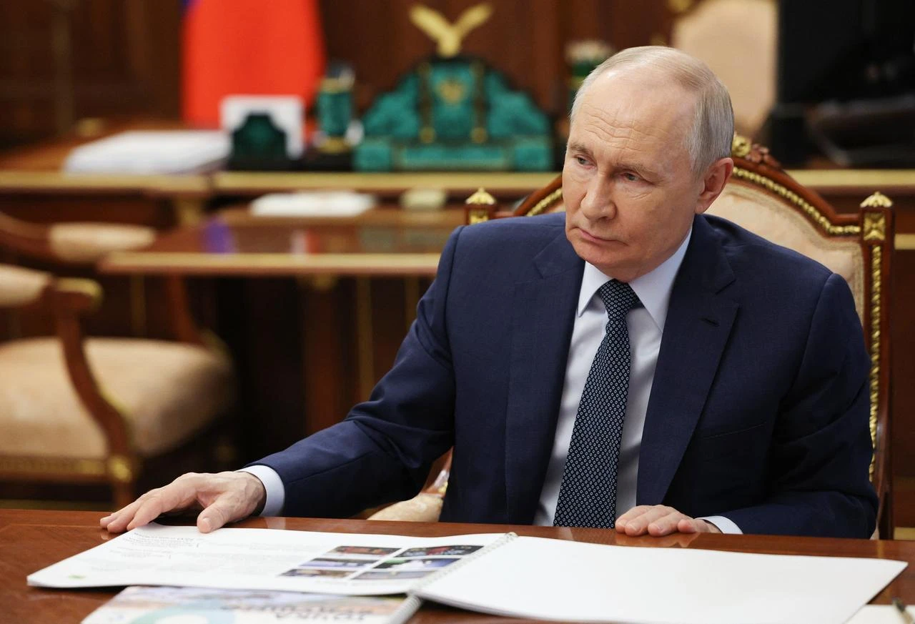 In this pool photograph distributed by the Russian state agency Sputnik, Russia's President Vladimir Putin attends a meeting with the head of the Republic of Sakha (Yakutia) in Moscow, July 14, 2026. (Photo via Sputnik/HO/AFP)